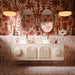 Luxury bathroom featuring Amalfi Brick Rouge Vintage Marble wall and floor tiles in a 5.4cm x 22cm format, paired with blush pink tones, decorative palm wallpaper, twin basins and warm brass accents.