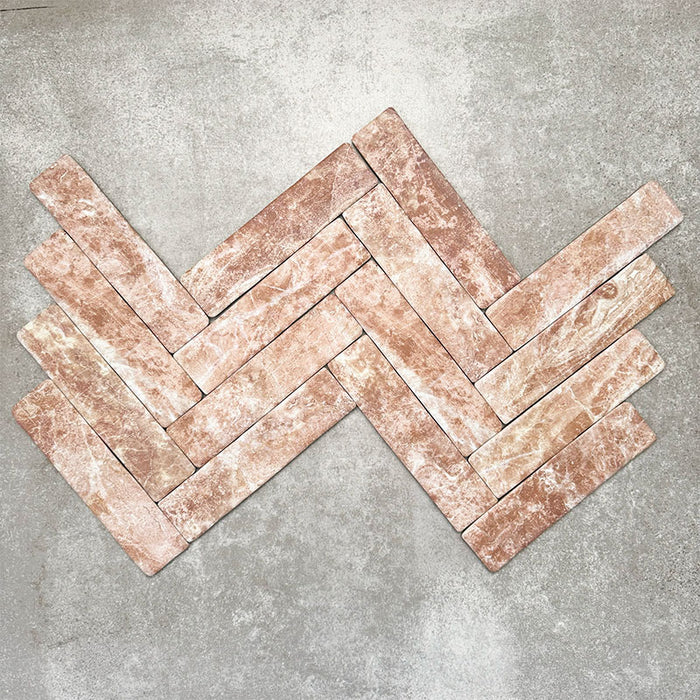 Product image of Amalfi Brick Rouge Vintage Marble wall and floor tiles in a 5.4cm x 22cm format, arranged in a herringbone pattern, showcasing warm blush pink marble effect detailing and natural tonal variation.