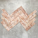 Product image of Amalfi Brick Rouge Vintage Marble wall and floor tiles in a 5.4cm x 22cm format, arranged in a herringbone pattern, showcasing warm blush pink marble effect detailing and natural tonal variation.