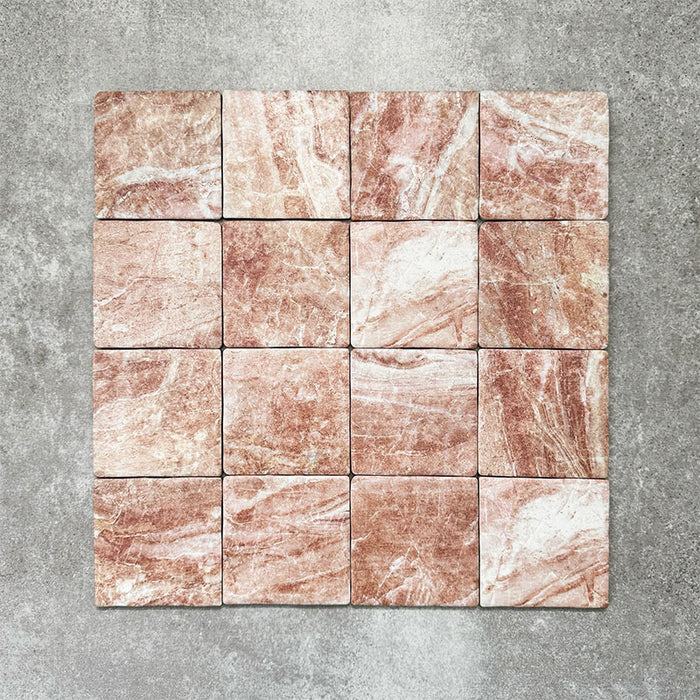 Product image of Amalfi Square Rouge Vintage Marble wall and floor tiles in an 11cm x 11cm format, featuring warm blush pink marble effect detailing, natural tonal variation and softly rounded edges.