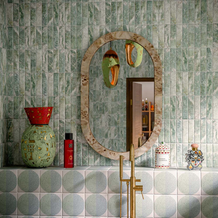 Bathroom featuring Amalfi Brick Salvia Vintage Marble 5.4x22cm wall and floor tiles, styled with a freestanding stone bath, green patterned floor tiles, brushed brass fixtures and botanical-inspired contemporary décor.