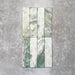 Product image of Amalfi Brick Salvia Vintage Marble wall and floor tiles in a 5.4cm x 22cm format, showcasing green and white marble effect detailing with natural veining and tonal variation.