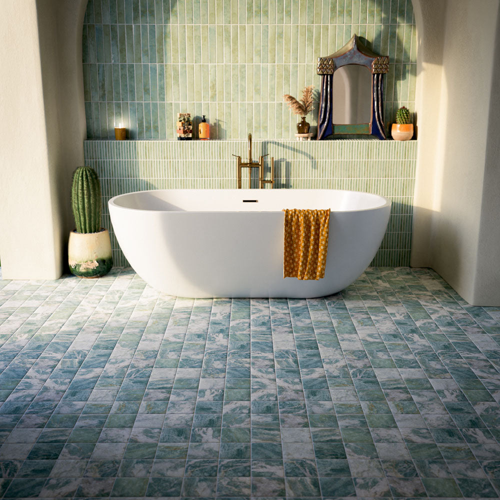 Bathroom featuring Amalfi Square Salvia 11x11cm vintage marble-effect wall and floor tiles, styled with a freestanding bath, brass fixtures, and soft green glazed wall tiles for a serene Mediterranean-inspired space.