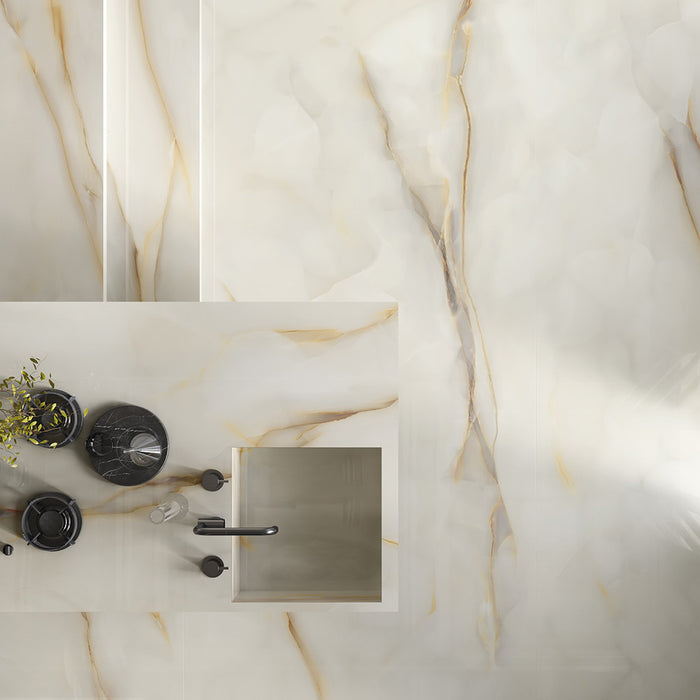 Flat lay bathroom vanity featuring Anastasia Pearl Onyx Matt 60 × 120cm stone effect tiles, with soft cream tones and delicate gold veining, paired with black fittings, integrated basin, and minimal, modern styling.