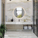 Bathroom interior featuring Anastasia Pearl Onyx Polished 60 × 120cm stone effect wall and floor tiles, with soft cream tones and gold veining, paired with a floating vanity, round mirror, glass shower enclosure, and black fittings.