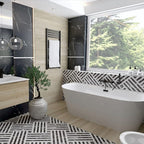 Bathroom interior featuring Art Deco Black & White marble effect patterned porcelain tiles 44 × 44cm, used across the floor and bath panel to create a bold, continuous geometric layout. The contrasting black and white tones introduce strong structure and rhythm, balanced with wood-effect wall panels, a freestanding bath, and matte black fittings for a clean, modern finish.