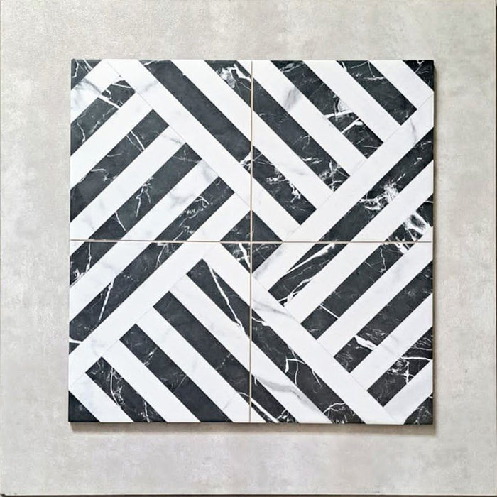 Flat lay of Art Deco Black & White marble effect patterned porcelain tiles 44 × 44cm, arranged to highlight the repeating geometric layout. The contrast between deep black marble effect segments and crisp white lines creates a bold, interlocking pattern with strong visual structure and movement.