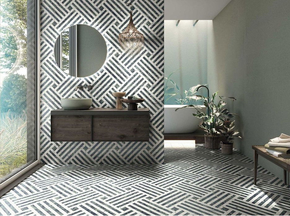 Bathroom interior featuring Art Deco Emerald Green marble effect patterned porcelain tiles 44 × 44cm, used across both wall and floor to create a continuous geometric layout. The bold linear pattern in deep green and white tones adds structure and movement, paired with a freestanding bath, wooden vanity unit, and natural greenery for a balanced, contemporary feel.