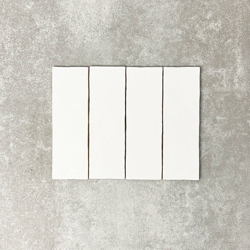 Close-up of Foundry Bricks Arctic White 6.5x20cm brick wall tiles, showcasing clean white tones with a smooth, lightly textured surface, highlighting a refined, contemporary finish with subtle tonal variation.