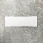 Close-up of Foundry Bricks Arctic White 6.5x20cm brick wall tile, showcasing clean white tones with a smooth, lightly textured surface and gently irregular edges, highlighting a refined, contemporary finish.