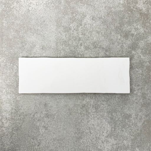 Close-up of Foundry Bricks Arctic White 6.5x20cm brick wall tile, showcasing clean white tones with a smooth, lightly textured surface and gently irregular edges, highlighting a refined, contemporary finish.
