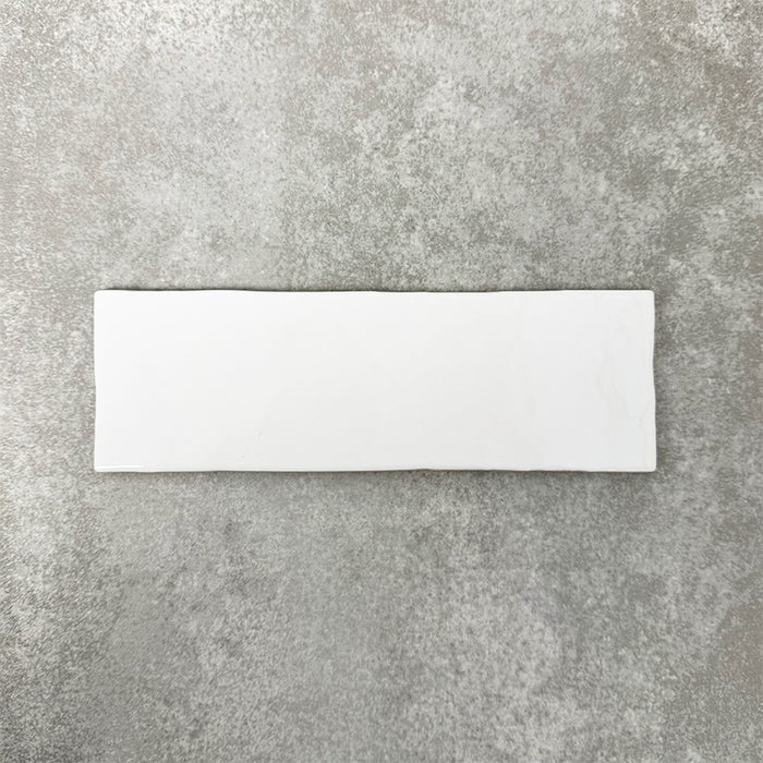 Close-up of Foundry Bricks Arctic White 6.5x20cm brick wall tile, showcasing clean white tones with a smooth, lightly textured surface and gently irregular edges, highlighting a refined, contemporary finish.