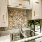 Kitchen splashback featuring Athens Multicoloured Hexagon Patchwork 17x15cm Moroccan-style tiles, displaying a geometric cube-effect pattern in soft pastel and earthy tones, paired with light cabinetry and warm wood handles for a playful yet contemporary finish.