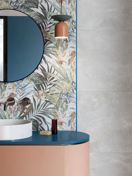 Bathroom featuring Bahamas 60 × 120cm wall tiles with a detailed tropical leaf design, used as a feature wall. Paired with soft concrete-effect tiles and a curved vanity for a balanced, contemporary finish.