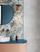 Bathroom featuring Bahamas 60 × 120cm wall tiles with a detailed tropical leaf design, used as a feature wall. Paired with soft concrete-effect tiles and a curved vanity for a balanced, contemporary finish.