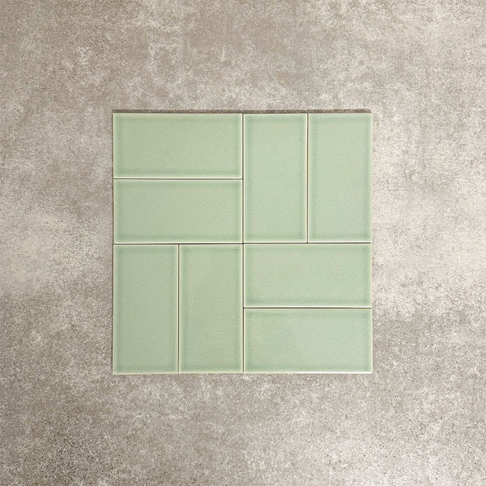 Pimlico Lime Green 7.5 × 15cm ceramic tiles with a crackle glaze finish, shown in a basketweave layout highlighting soft green tones, subtle texture and versatile design options for bathroom or kitchen walls.