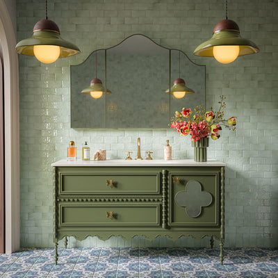 Bathroom featuring Balthazar Blue 20cm x 20cm Victorian Moroccan-style floor tiles, paired with Liberty Mint Green gloss wall tiles, a sage green vanity unit, brass fittings and decorative lighting.
