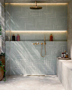 Bathroom featuring Baresi Cream 3D Terrazzo Effect 60x120cm porcelain tiles, showcasing a warm cream terrazzo effect design with subtle texture, paired with sage green feature wall tiles, brass fittings and a contemporary walk-in shower.