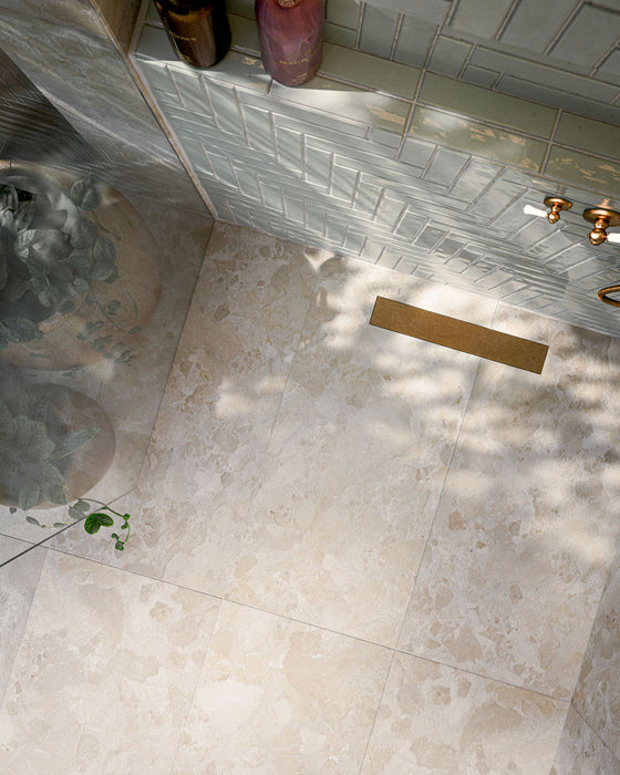 Bathroom featuring Baresi Cream 3D Terrazzo Effect 60x120cm porcelain tiles, showcasing a warm cream terrazzo effect design with subtle texture, paired with sage green feature wall tiles, brass fittings and a contemporary walk-in shower.