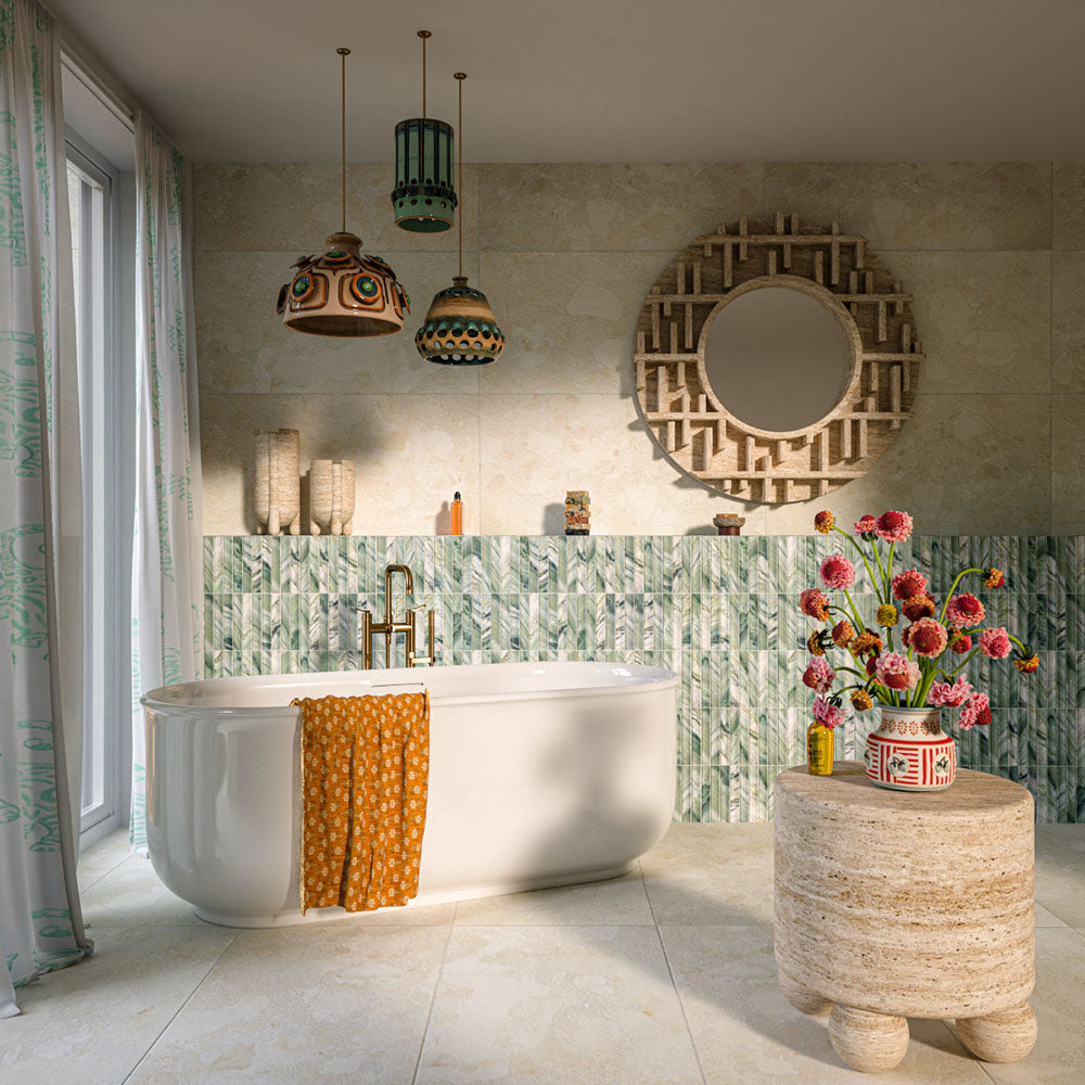 Bathroom featuring Baresi Puro Light 3D 60x120cm terrazzo-effect porcelain wall and floor tiles in warm beige tones, styled with green textured feature tiles, a freestanding bath, brass fixtures, and bohemian-inspired décor.