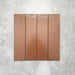 Baroque Cotto porcelain wall and floor tile in a 9.1cm x 37.5cm format, featuring a warm terracotta metallic finish with gently distressed edges, displayed against a textured concrete-effect background.