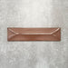 Baroque Decor Cotto porcelain wall tile in a 9.1cm x 37.5cm format, featuring a warm terracotta metallic finish with a raised geometric relief design and gently distressed edges, displayed against a textured concrete-effect background.
