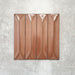 Baroque Decor Cotto porcelain wall tile in a 9.1cm x 37.5cm format, featuring a warm terracotta metallic finish with a raised geometric relief design and gently distressed edges, displayed against a textured concrete-effect background.