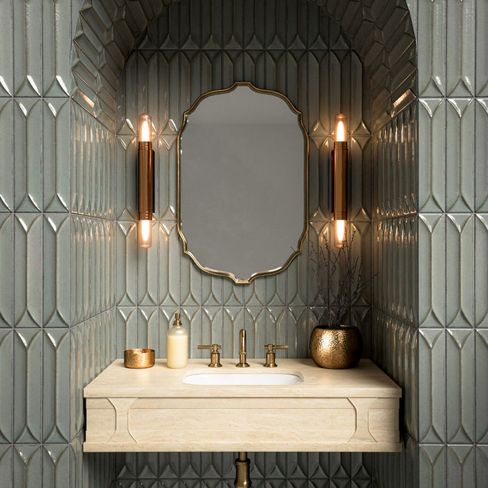 Bathroom vanity area featuring Baroque Decor Lichen Green 9.1x37.5cm porcelain wall tiles, showcasing a glossy fluted design in soft green tones, paired with a stone basin, brass fittings and warm ambient lighting.