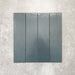 Baroque Laguna Blue porcelain wall and floor tile in a 9.1cm x 37.5cm format, featuring a deep blue metallic finish with gently distressed edges, displayed against a textured concrete-effect background.