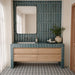 Bathroom featuring Baroque Decor Laguna Blue 9.1cm x 37.5cm porcelain wall tiles, with raised geometric detailing, paired with a wooden vanity, patterned floor tiles and neutral décor.