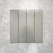 Baroque Lichen Green porcelain wall and floor tile in a 9.1cm x 37.5cm format, featuring a soft sage green metallic finish with gently distressed edges, displayed against a textured concrete-effect background.