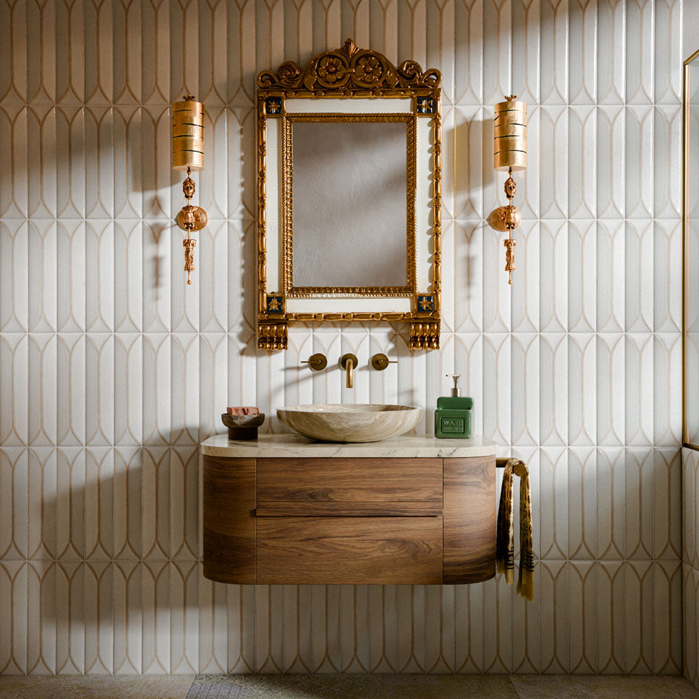 Interior featuring Baroque Decor Vanilla porcelain wall tiles, creating a luxurious statement wall with an elegant geometric relief pattern. The soft vanilla tones and subtle texture add depth and movement while maintaining a calm, neutral palette. Paired with rich walnut furniture, marble accents and antique brass details, the space balances contemporary design with classic sophistication. The decorative surface catches the light beautifully, bringing warmth, texture and a refined architectural feel to the