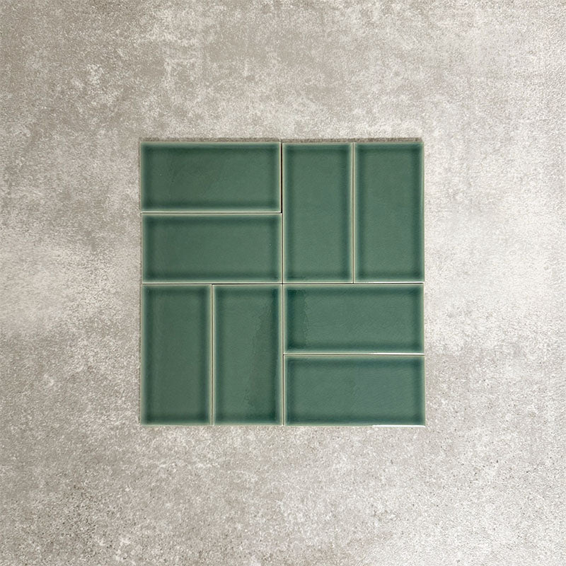 Pimlico Golders Green 7.5 × 15cm ceramic wall tiles with a crackle glaze finish, shown in a basketweave layout highlighting rich green tones, subtle texture and versatile design for kitchens and bathrooms.