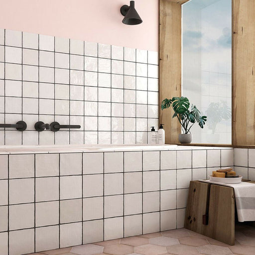 Zellige White square tiles installed in a bathroom, featuring a glossy white finish with visible grout lines and subtle surface variation.