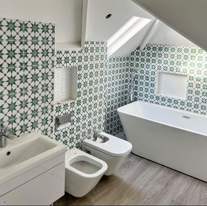 Bathroom interior featuring Agadir Green Moroccan-style 20x20cm porcelain wall tiles, showcasing a repeating geometric star pattern in green and white, styled with a freestanding bath, modern sanitaryware and a bright, airy layout.