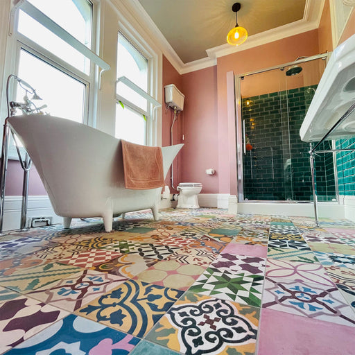 Bathroom interior featuring Fayrouz Patchwork 20×20cm Moroccan-style porcelain floor tiles, combining colourful geometric and floral patterns for a bold, decorative patchwork effect.