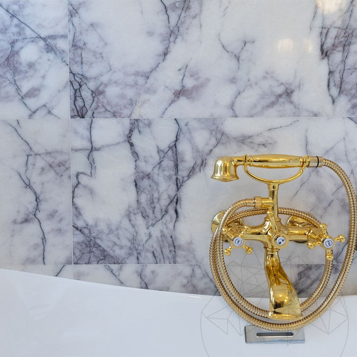 Bathroom interior featuring Fayrouz Lilac 30.5x61cm natural marble tiles with a honed finish, installed across the walls and floor to showcase a white base with soft lilac and grey veining, creating an elegant, spa-like setting with refined natural variation.