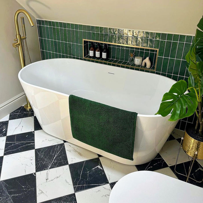 Bathroom featuring Florence Calacatta White 25x25cm marble-effect porcelain floor tiles laid in a classic black and white checkerboard pattern, styled with a freestanding bath, brass fixtures and deep green wall tiles for an elegant, spa-inspired finish.