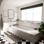 Nairobi gloss white handmade-effect tiles styled in a bathroom setting, featuring a brick-laid wall design paired with a built-in bath, black and white patterned floor tiles, and soft natural light.