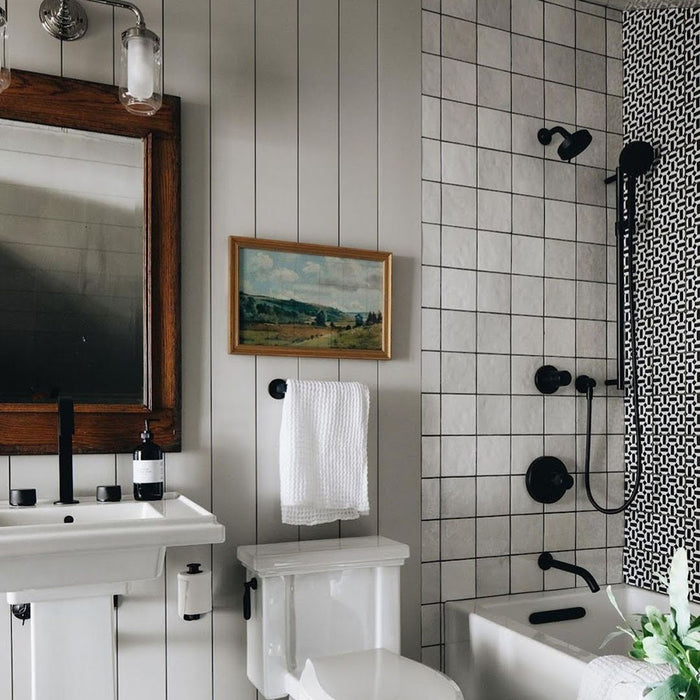 Bathroom featuring Zellige White square tiles in a neat grid layout, paired with black fixtures and classic fittings for a timeless, modern look.