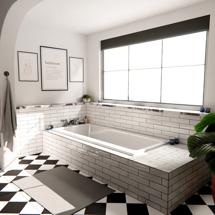 Nairobi gloss white handmade-effect tiles styled in a bathroom setting, featuring a brick-laid wall design paired with a built-in bath, black and white patterned floor tiles, and soft natural light.
