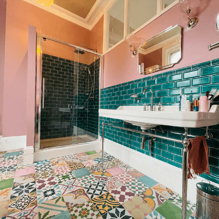 Bathroom interior featuring Fayrouz Patchwork 20×20cm Moroccan-style porcelain floor tiles, combining colourful geometric and floral patterns for a bold, decorative patchwork effect.