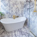 Bathroom interior featuring Fayrouz Lilac 30.5x61cm natural marble tiles with a honed finish, installed across the walls and floor to showcase a white base with soft lilac and grey veining, creating an elegant, spa-like setting with refined natural variation.