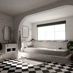 Nairobi gloss white handmade-effect tiles styled in a bathroom setting, featuring a brick-laid wall design paired with a built-in bath, black and white patterned floor tiles, and soft natural light.