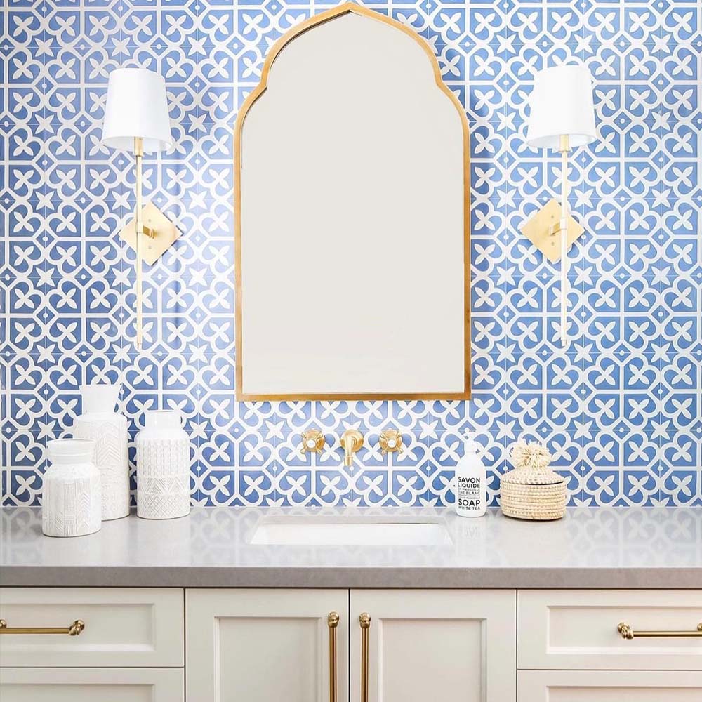 Ivy Blue Victorian Moroccan style 20x20cm patterned tiles, used as a bathroom wall feature behind a vanity with brass fittings and a decorative mirror.