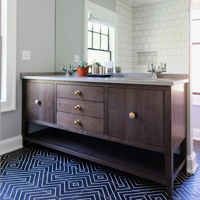 Bathroom floor featuring Almeria Jilani Black Moroccan-style porcelain tiles in a bold white line geometric chevron pattern, 20x20cm, paired with a dark wood vanity for a striking contrast.