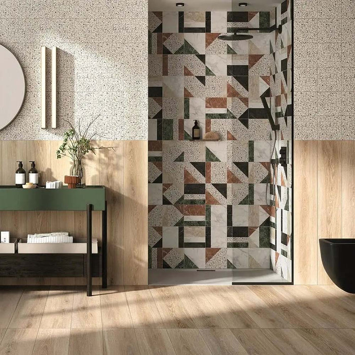 Bathroom featuring Turin Terrazzo Blanco Decor Patchwork porcelain wall tiles in a 20 × 20cm format, showcasing a bold geometric patchwork design in soft terrazzo tones, used as a striking shower feature wall and paired with warm wood finishes and contemporary fittings.