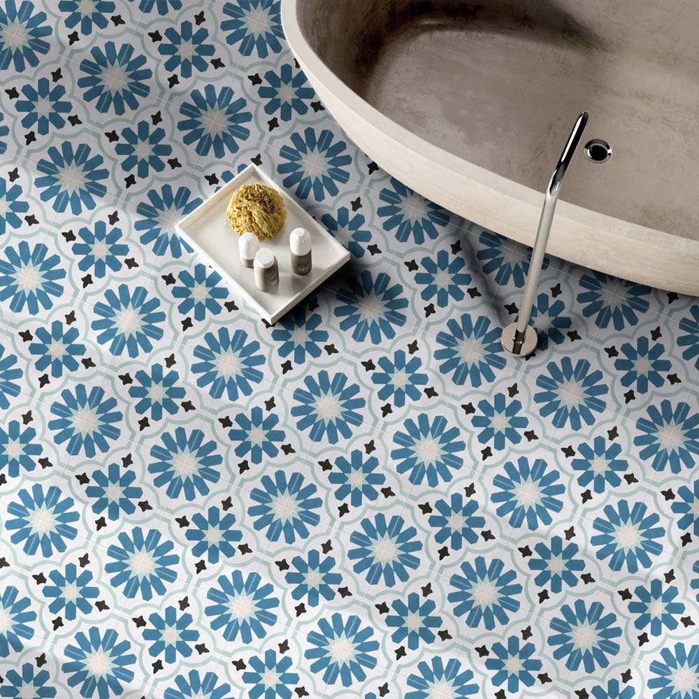 Bathroom featuring Clara Teal Victorian Moroccan-style porcelain floor tiles in a 20 × 20cm format, creating a bold patterned floor beneath a freestanding bath.