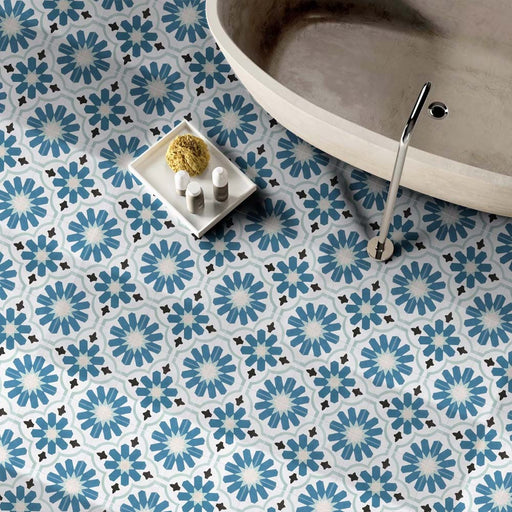 Bathroom featuring Clara Teal Victorian Moroccan-style porcelain floor tiles in a 20 × 20cm format, creating a bold patterned floor beneath a freestanding bath.