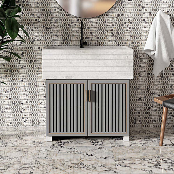 Bathroom interior featuring Fayrouz Picasso 30.5x61cm natural marble tiles with a honed finish, installed on the floor to showcase a white base with bold grey, green and warm gold veining, creating a statement surface with rich natural movement and variation.